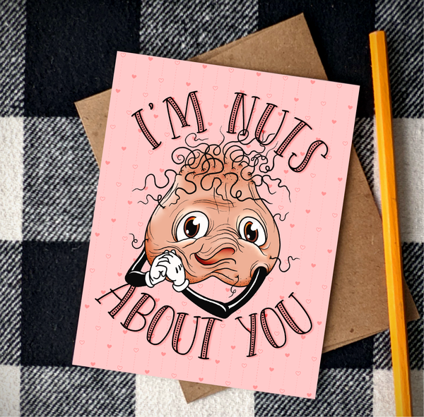 cute adult humor valentines day greeting card featuring a hand drawn pair of testicles over a heart background with the words I'm nuts about you above and below the balls